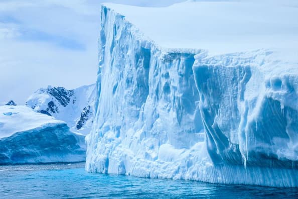 A massive iceberg floating in icy Antarctic waters.